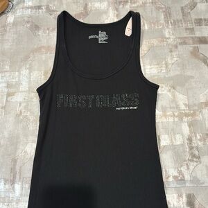Victoria’s Secret tank top. “FIRST CLASS”
